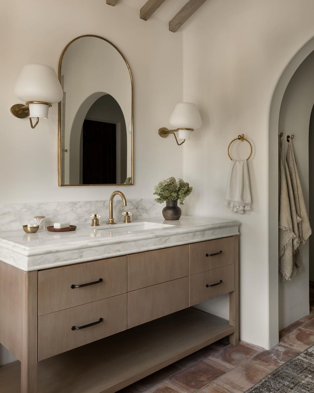 A sophisticated bathroom vanity design with arch details