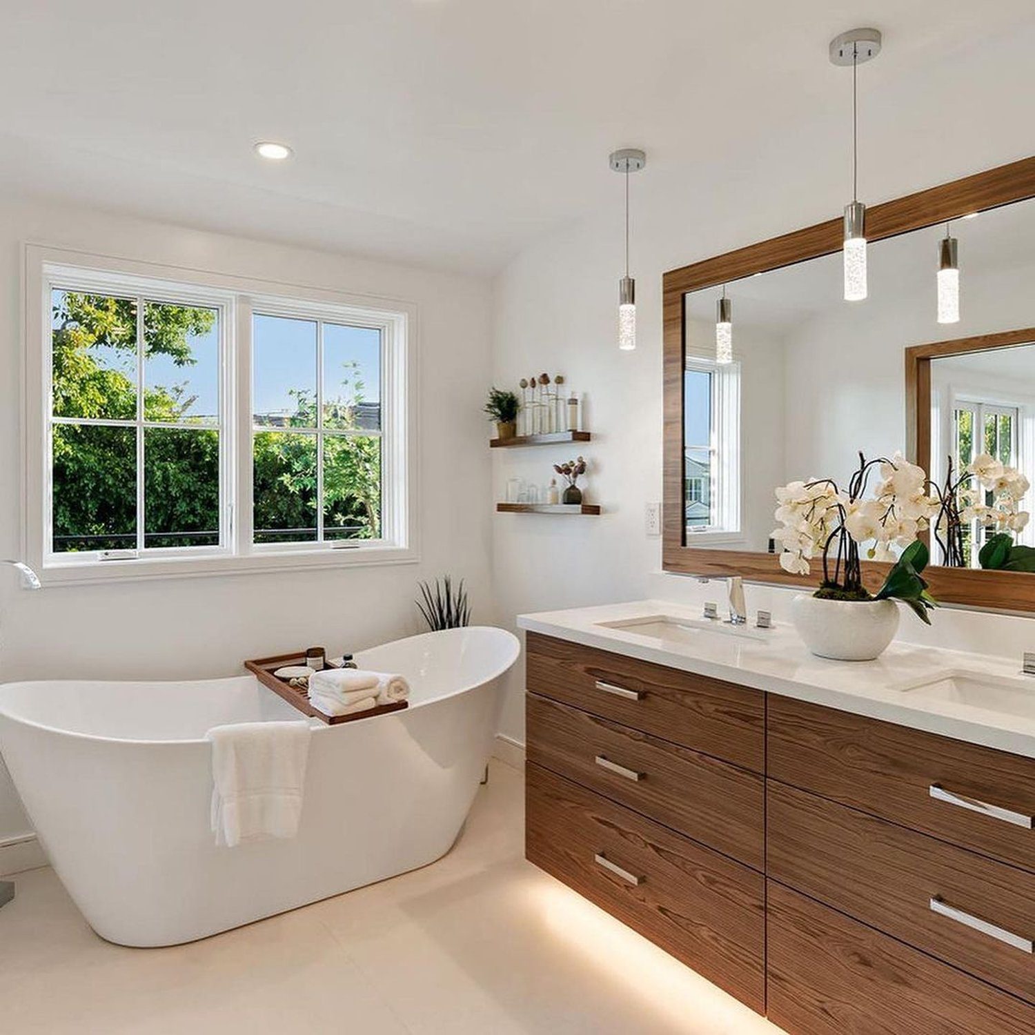 A bright and modern bathroom featuring an elegant freestanding tub