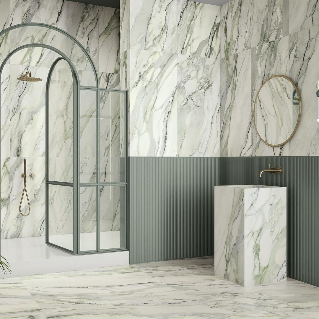 A modern bathroom featuring green and white marble details