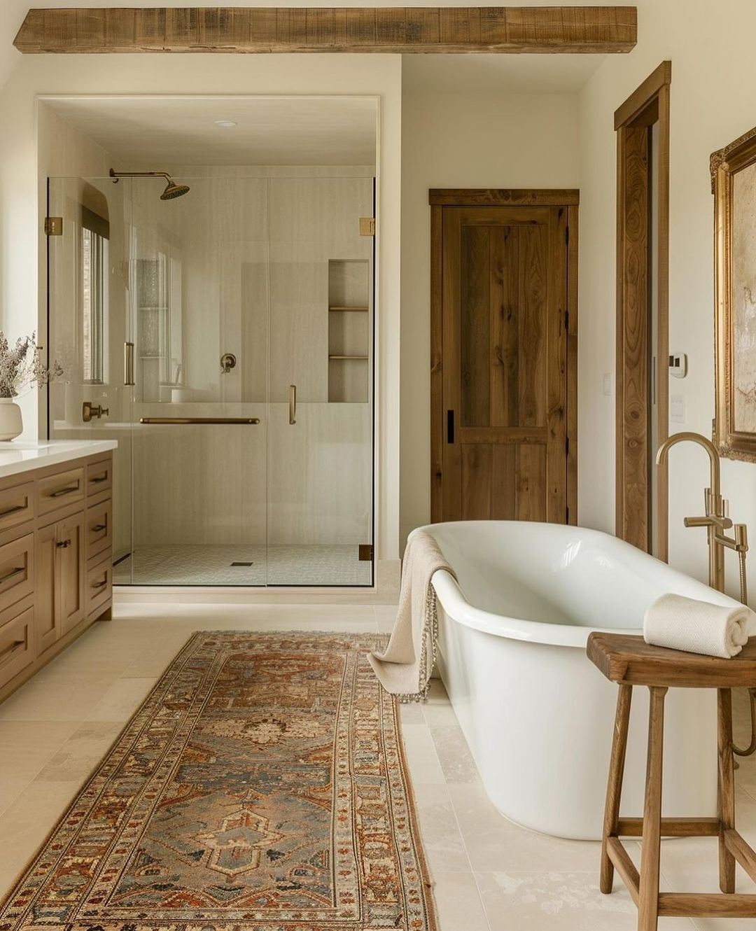 A warm and inviting modern bathroom with a freestanding bathtub and wooden accents