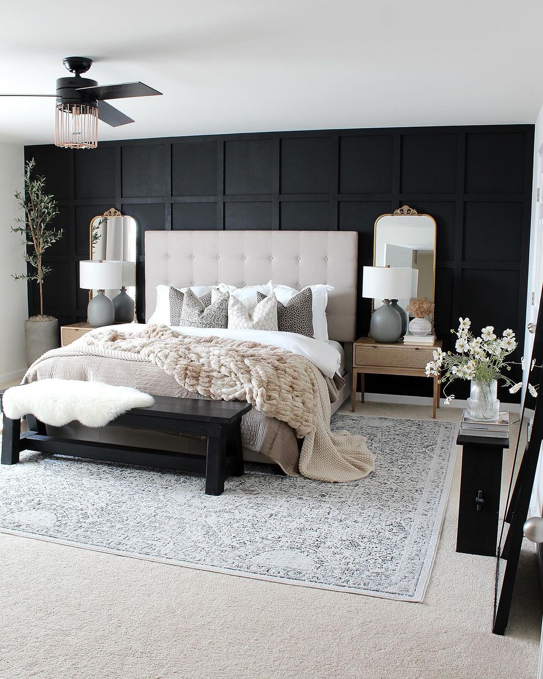 Chic and modern bedroom with bold black accent wall