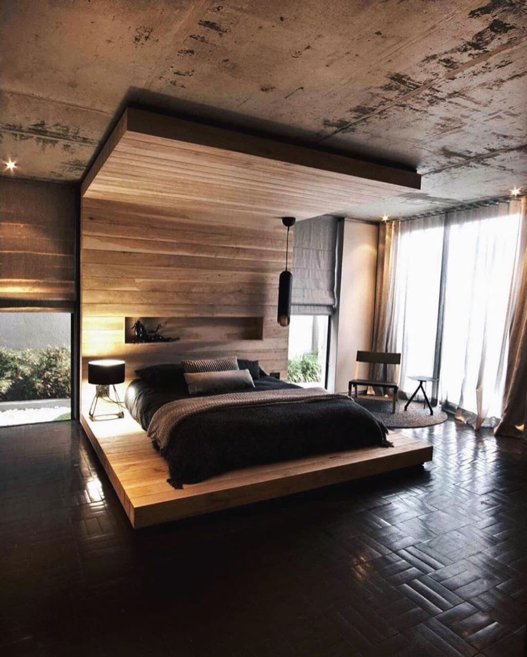 A modern bedroom featuring wood accents and a raised bed platform