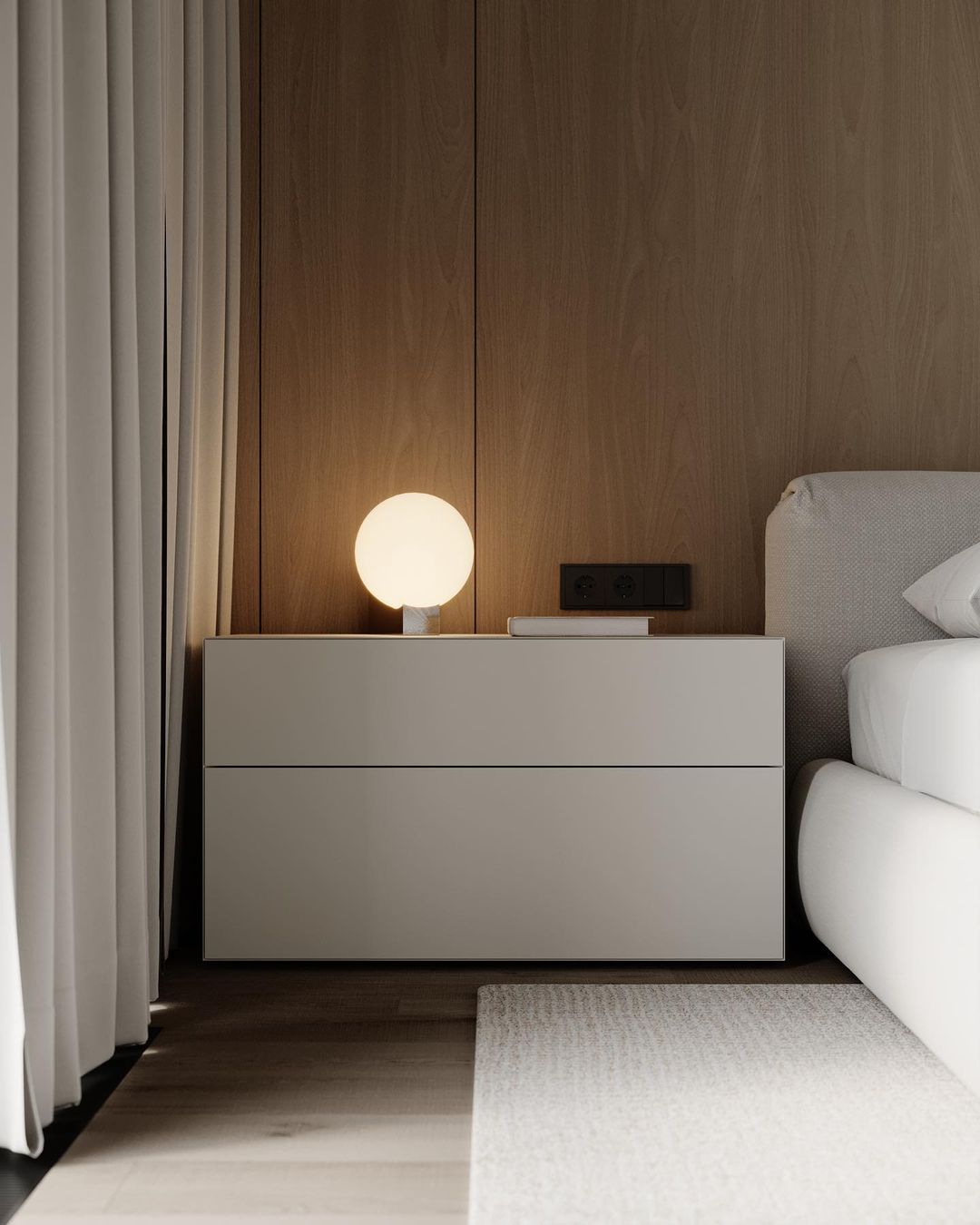 A minimalist bedroom with a spherical table lamp