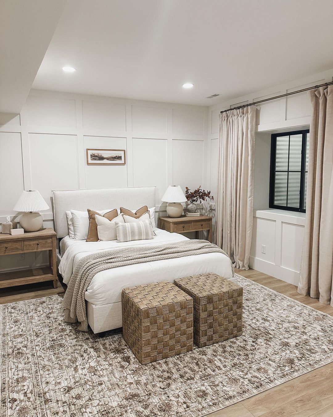 A chic and modern bedroom featuring a neutral color palette