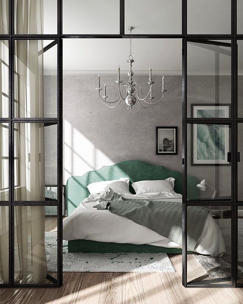 A modern bedroom featuring a green upholstered bed