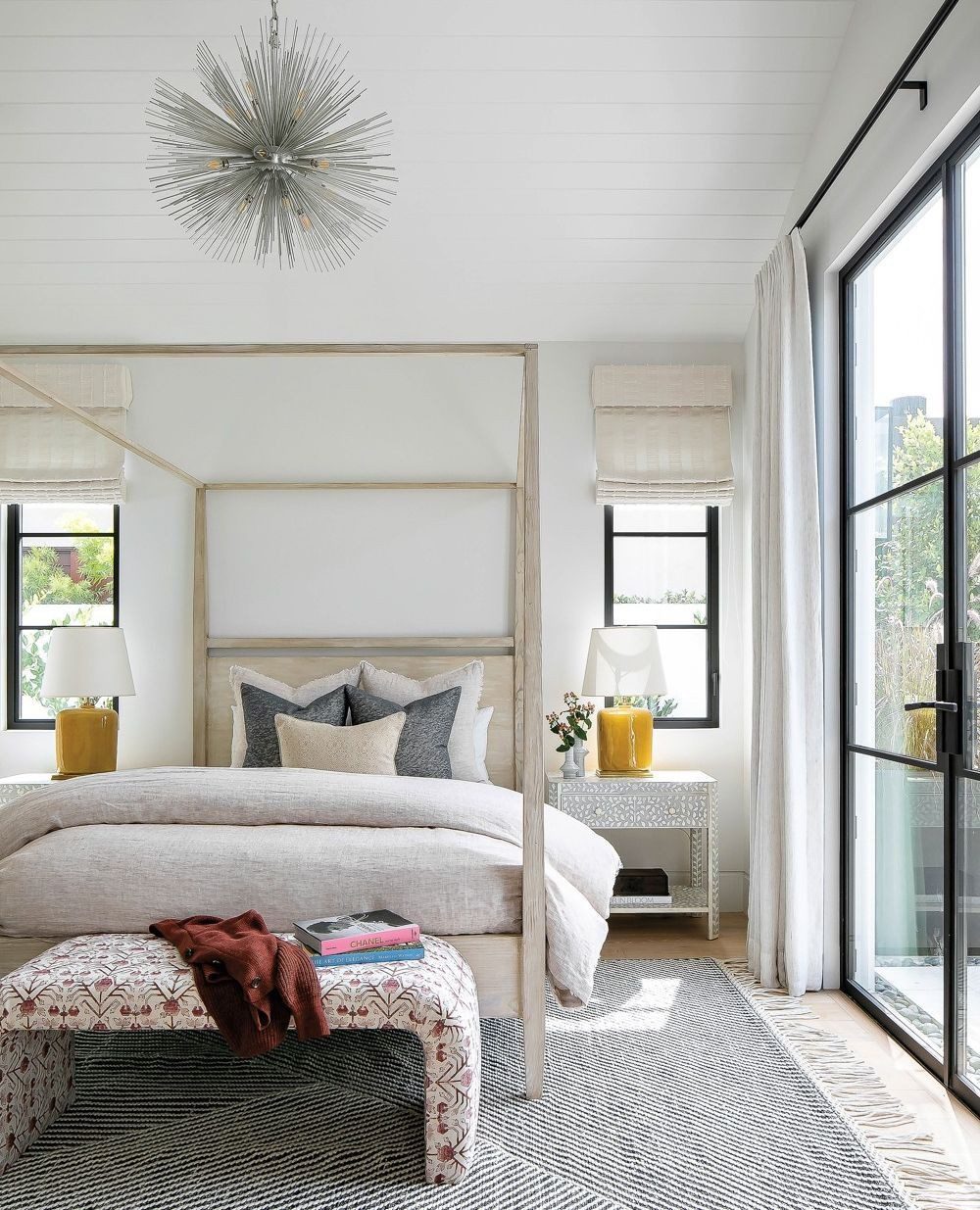 A modern bedroom featuring a four-poster bed and contemporary decor