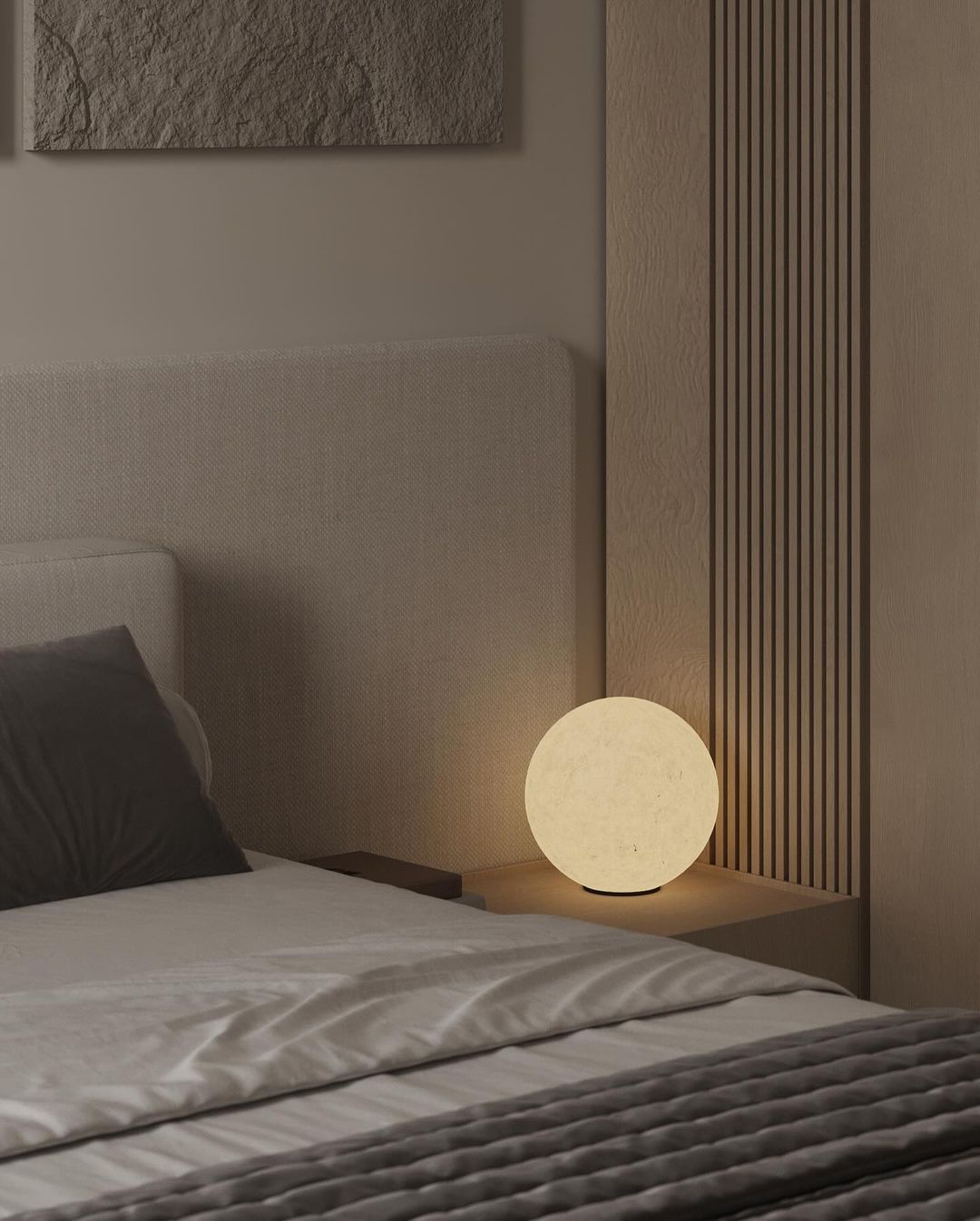 A modern bedroom featuring a unique spherical lamp on a bedside table