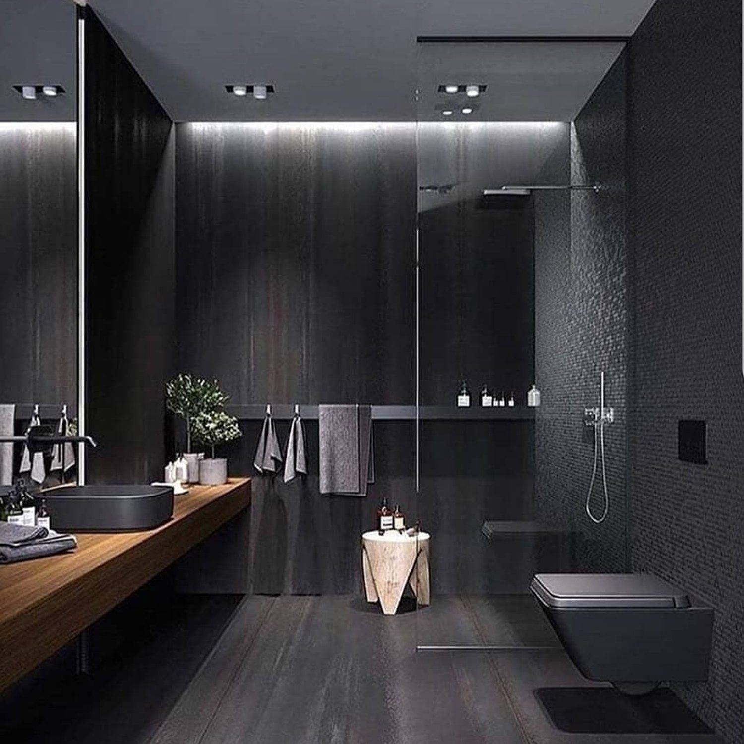 A sleek and modern bathroom with a monochrome black theme