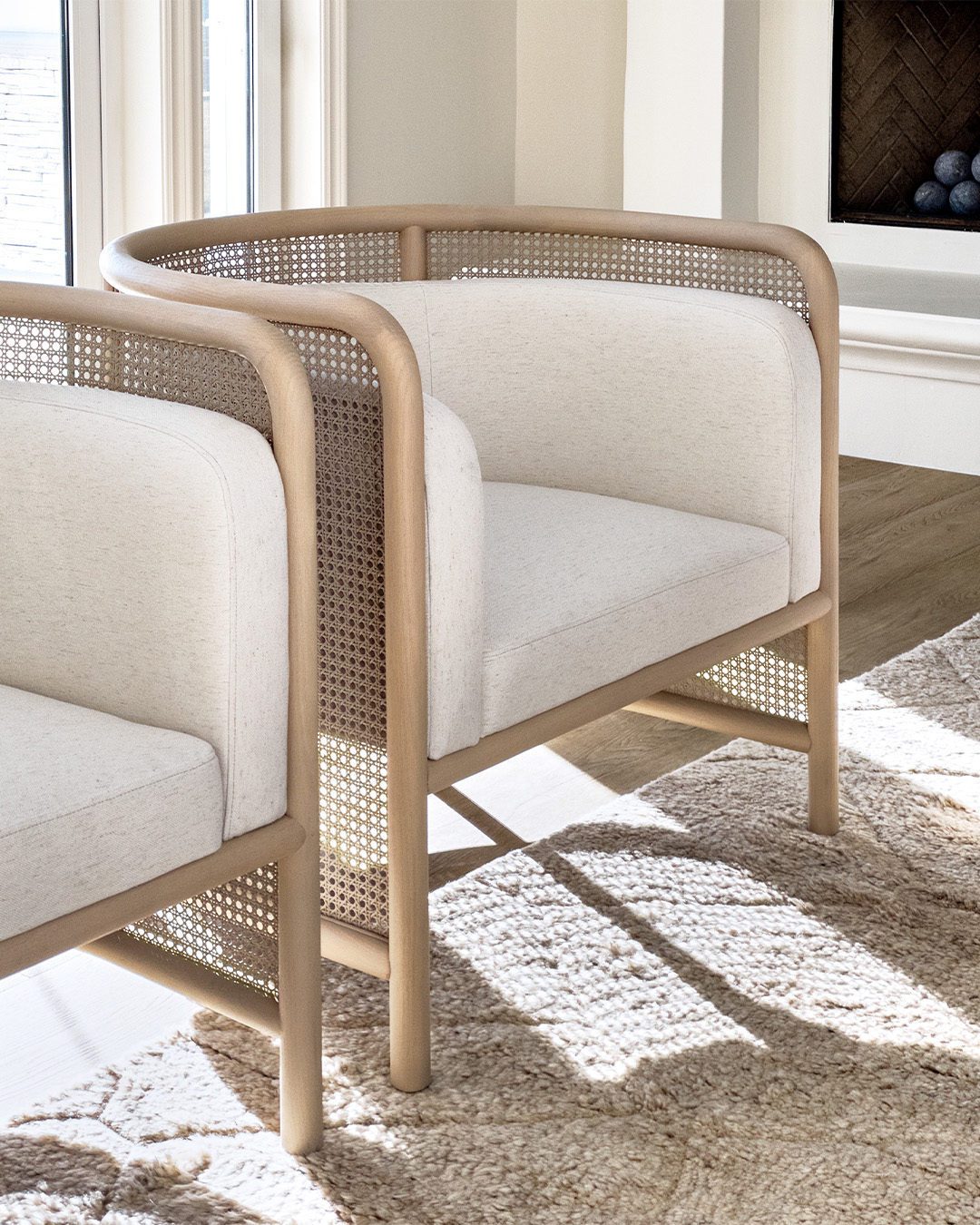 A modern chair with a sleek wooden frame and perforated back panel