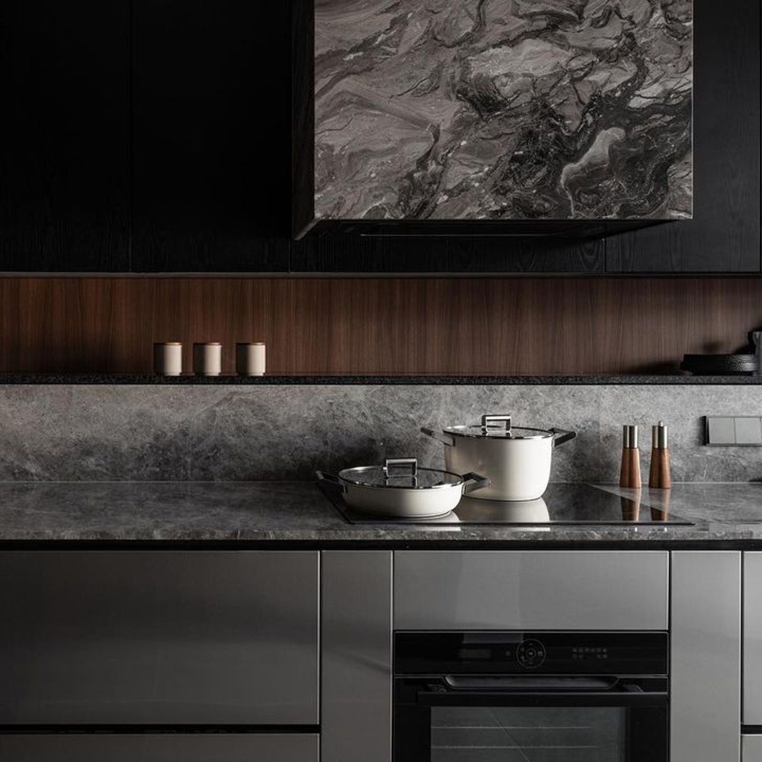 A sleek modern kitchen with sophisticated dark cabinetry