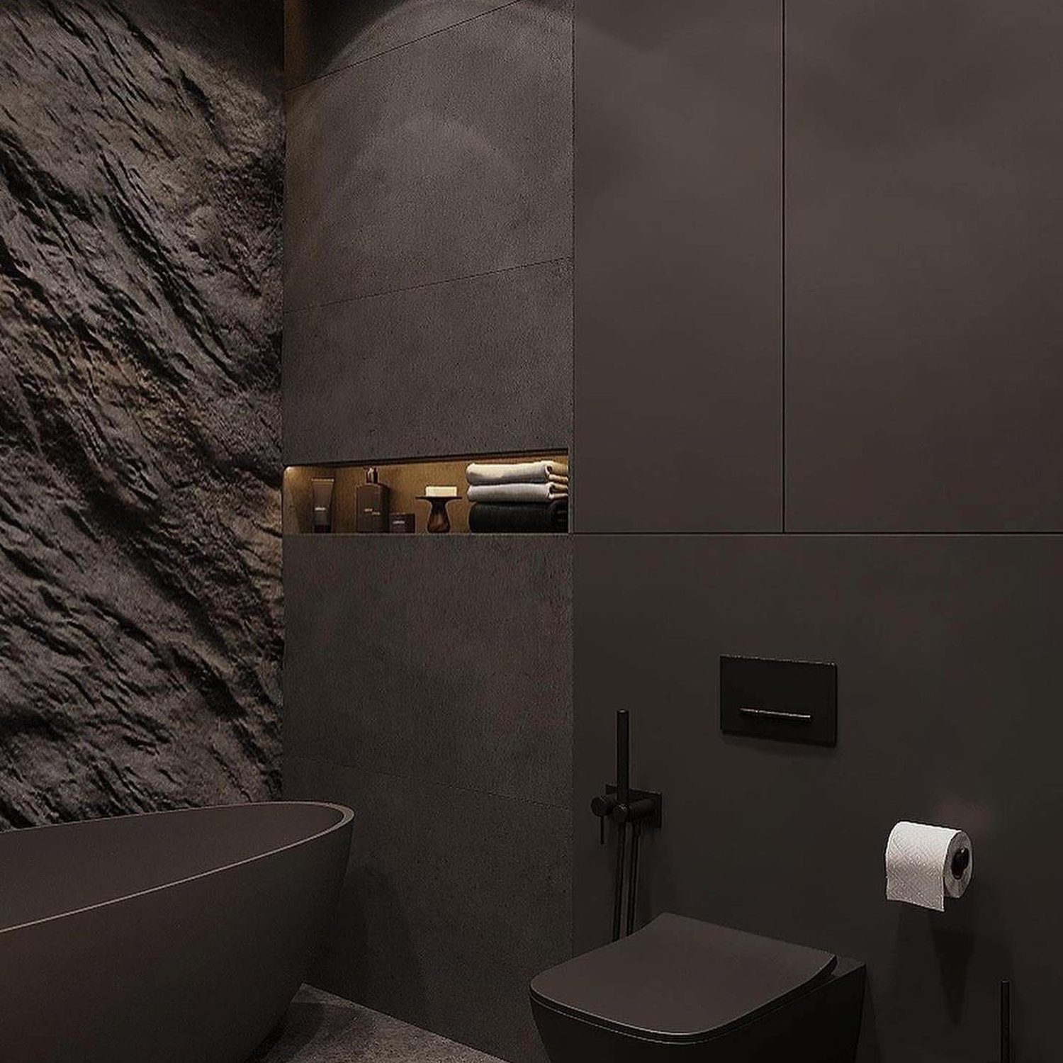 A modern, dark-themed bathroom featuring contrasting textures.