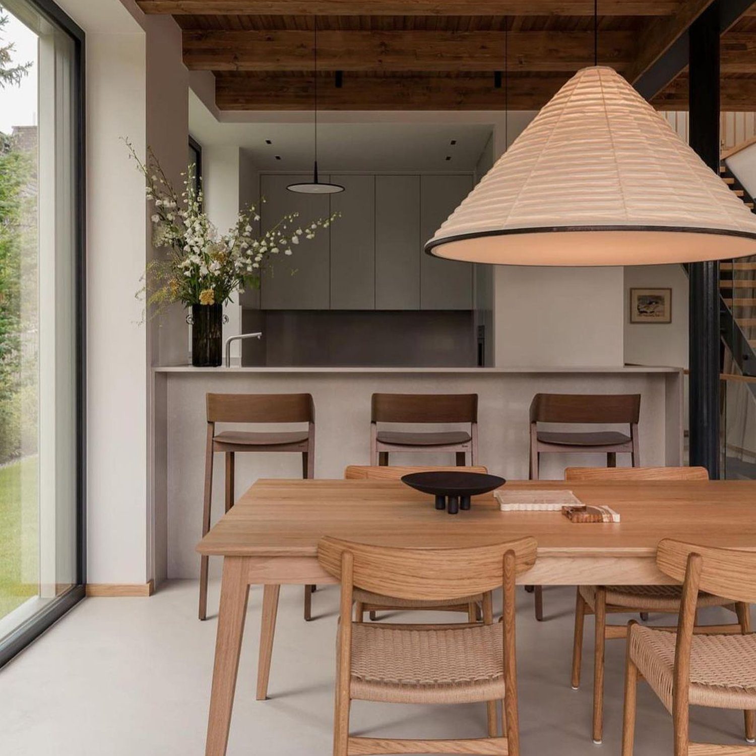 A modern dining area with rich wooden textures and minimalist design elements