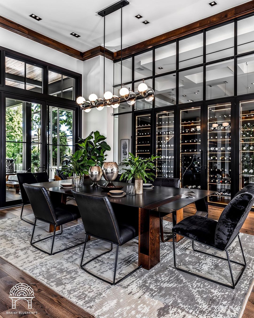 Stylish and modern dining space featuring black chairs and wooden table