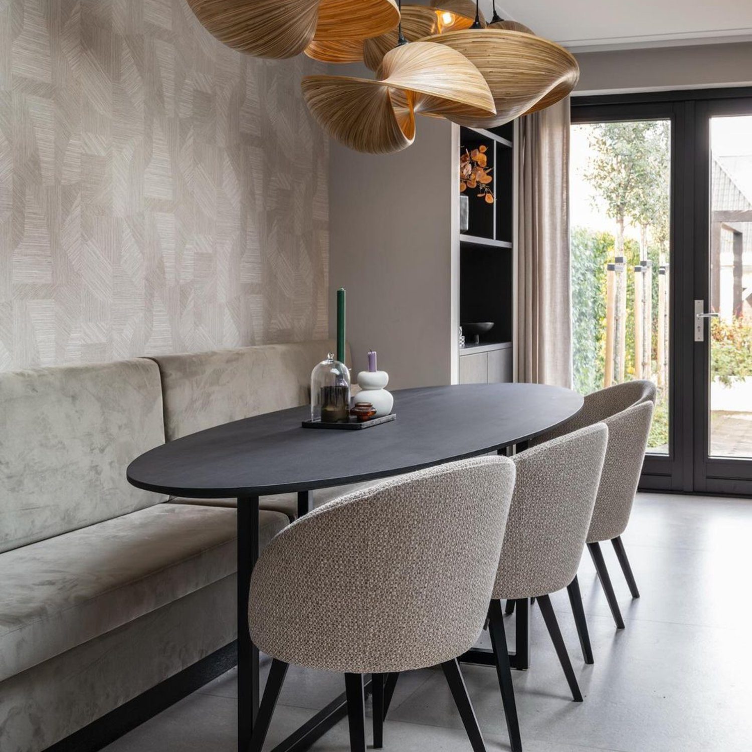 Elegant dining space with unique lighting fixture and a mix of bench seating and chairs