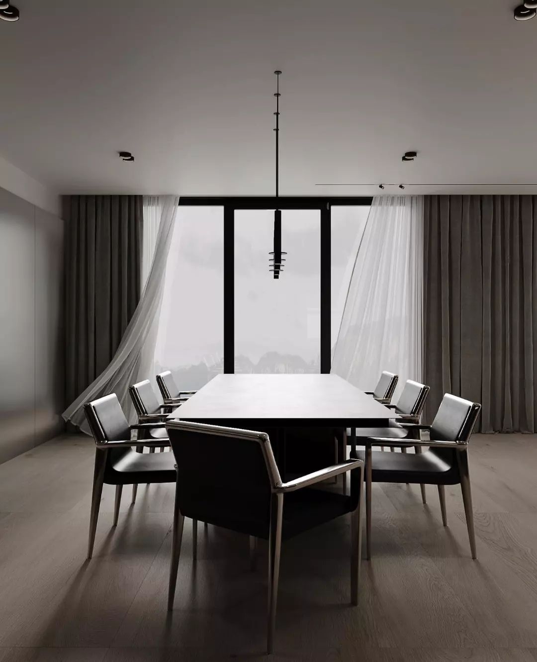 A minimalist dining room with a large square table and black chairs