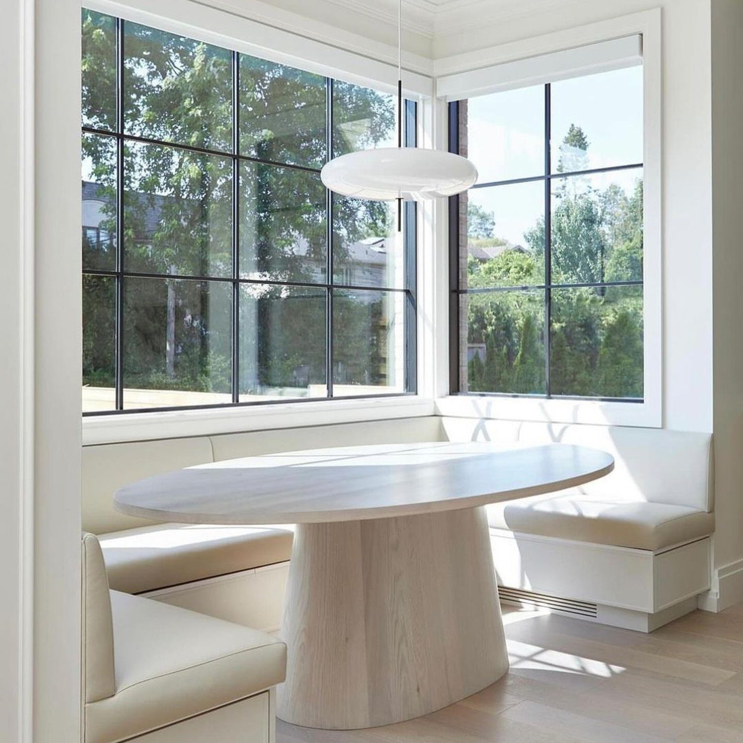 A serene dining nook with expansive windows