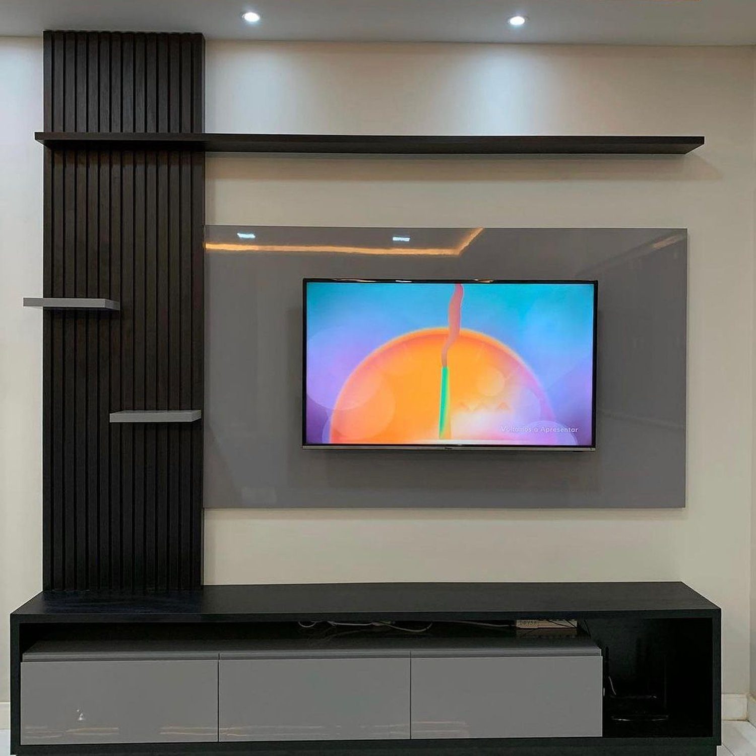 A sleek and modern entertainment area with wall-mounted TV and ambient lighting