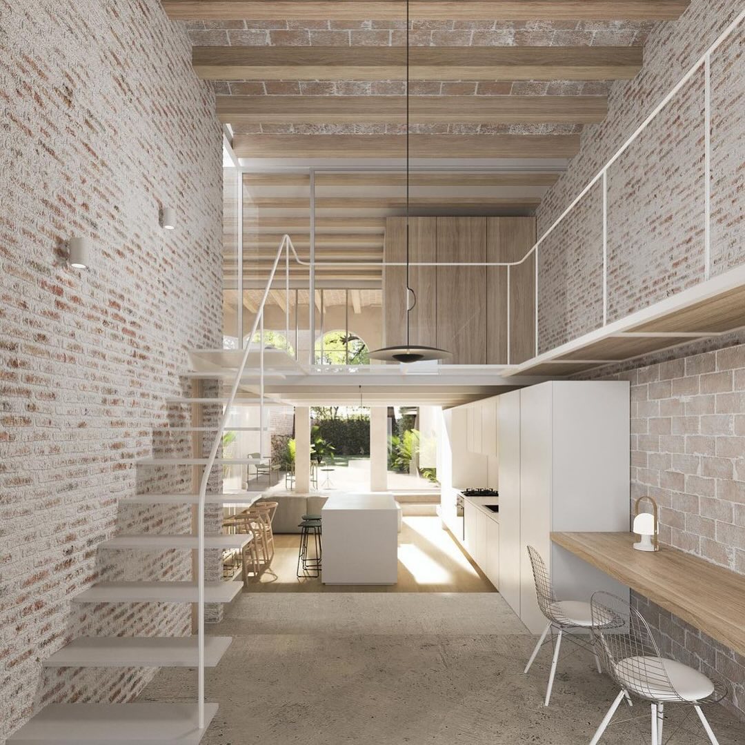 A modern kitchen space with exposed brick walls and wooden accents