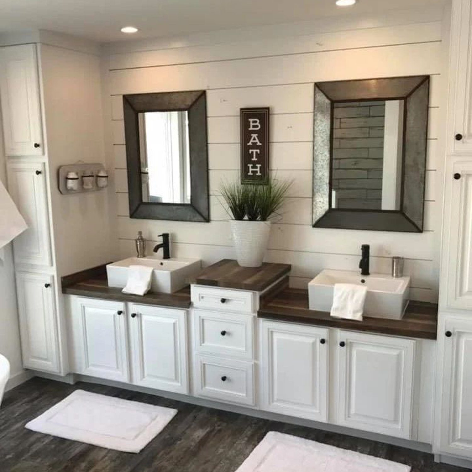 A modern farmhouse style bathroom with dual vessel sinks