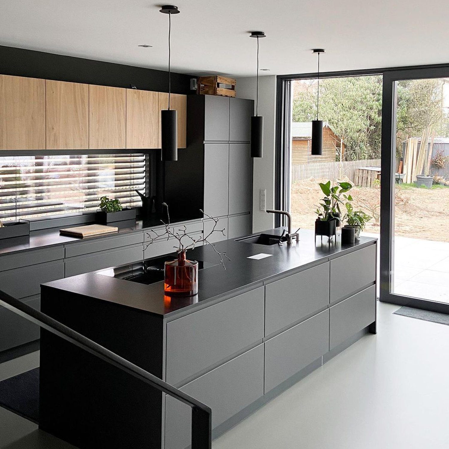 A sleek and modern kitchen with gray cabinetry