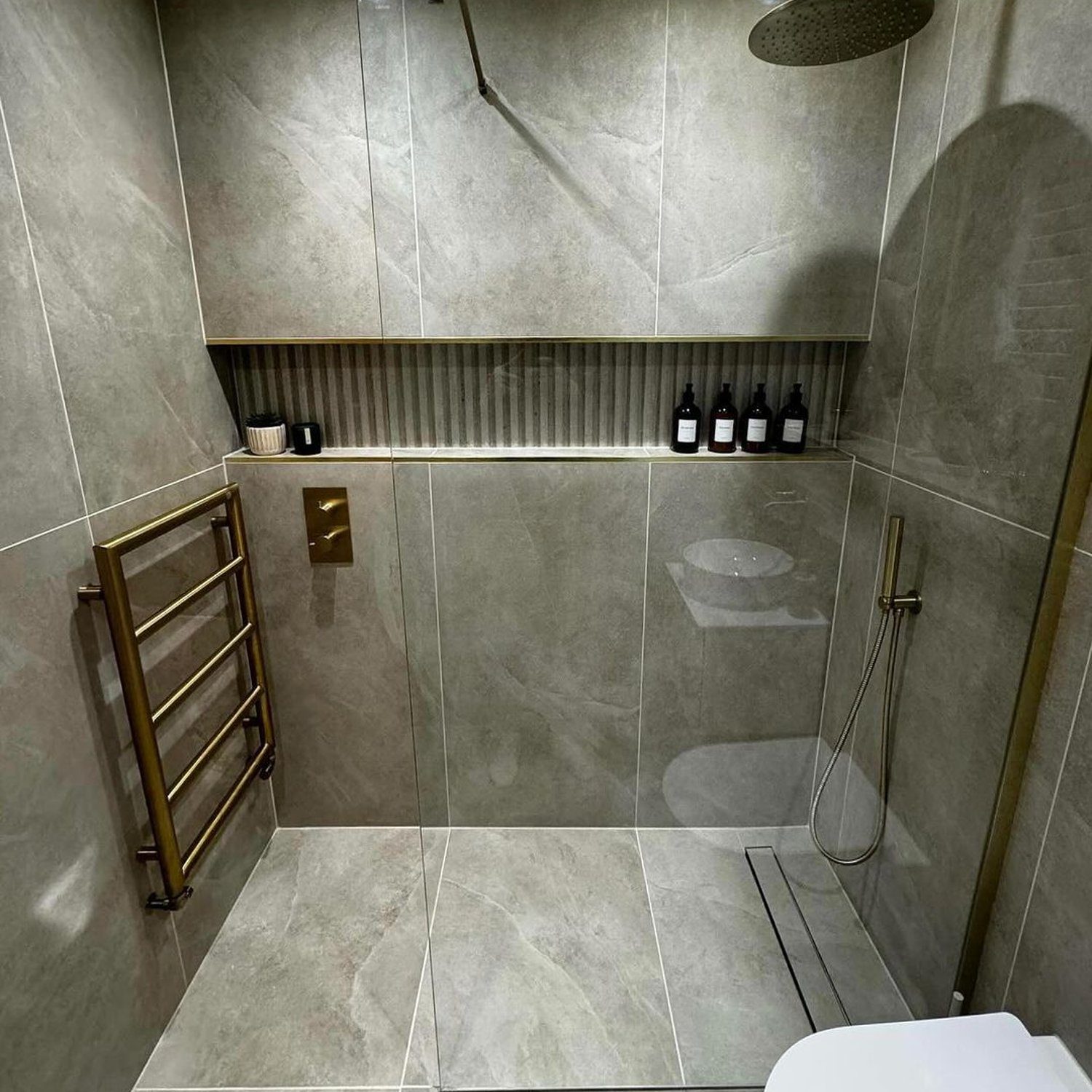 A modern, sleek bathroom featuring grey tiles