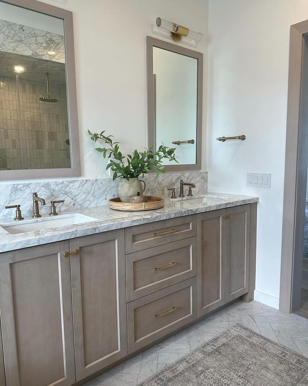 A modern bathroom featuring grey wooden cabinetry