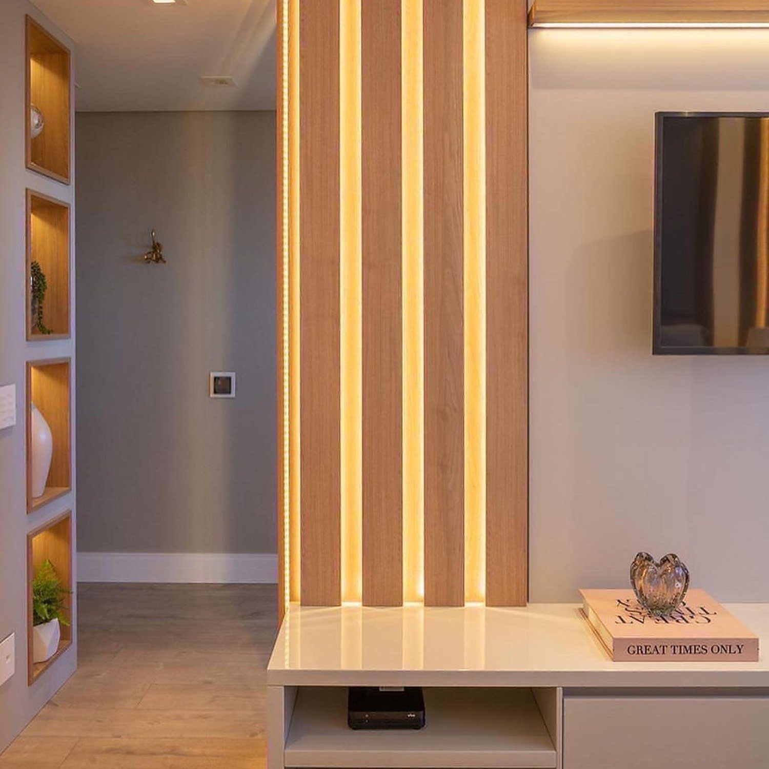 A modern hallway featuring warm wood-toned LED-lined panels