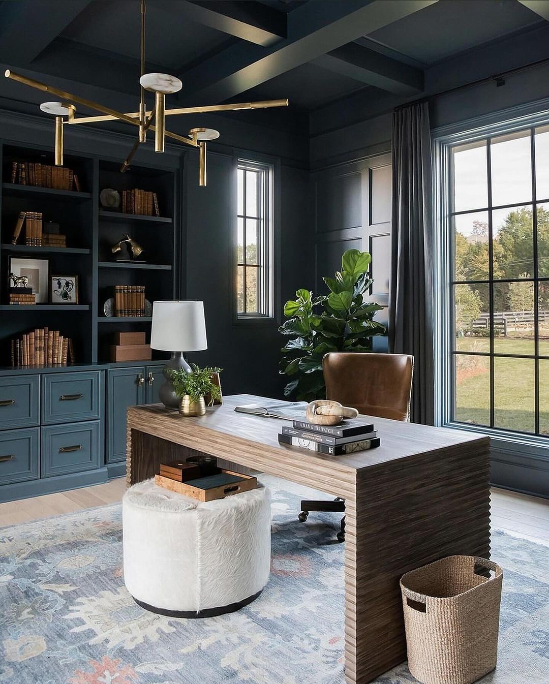 A well-designed modern home office with striking dark tones and sleek furniture