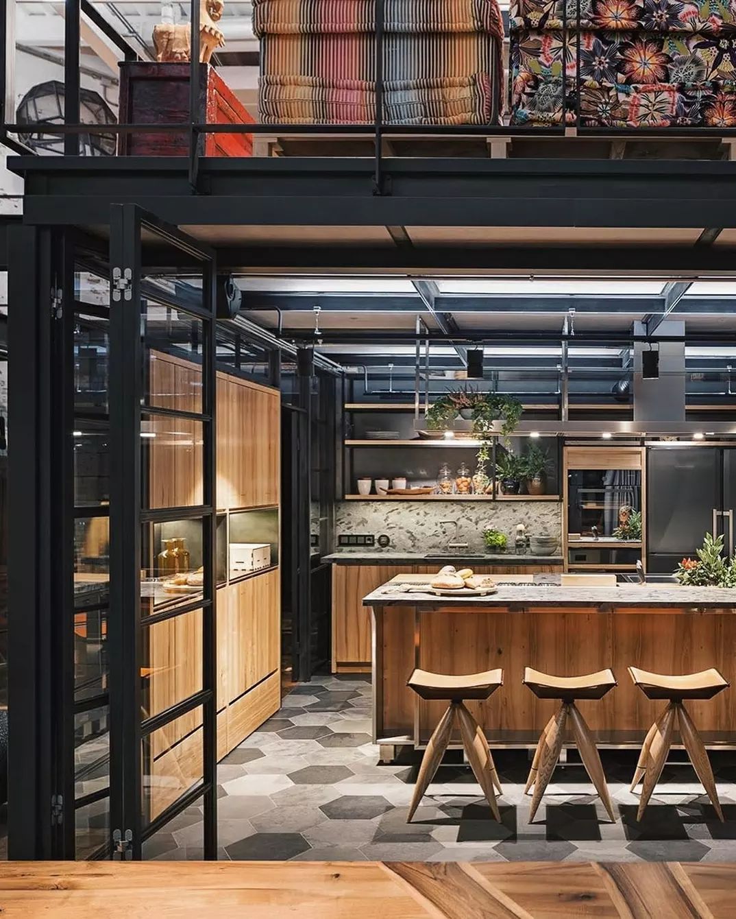 A modern industrial-style kitchen featuring warm wood tones and cool metallic accents