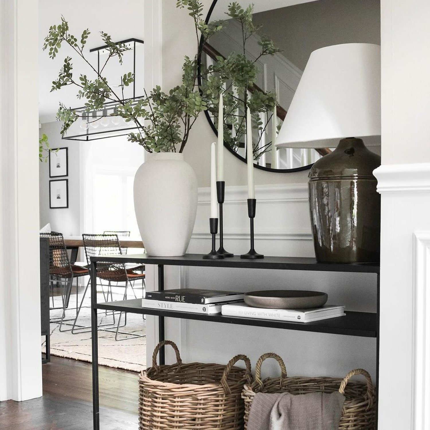 Elegantly arranged living room corner with black shelving unit