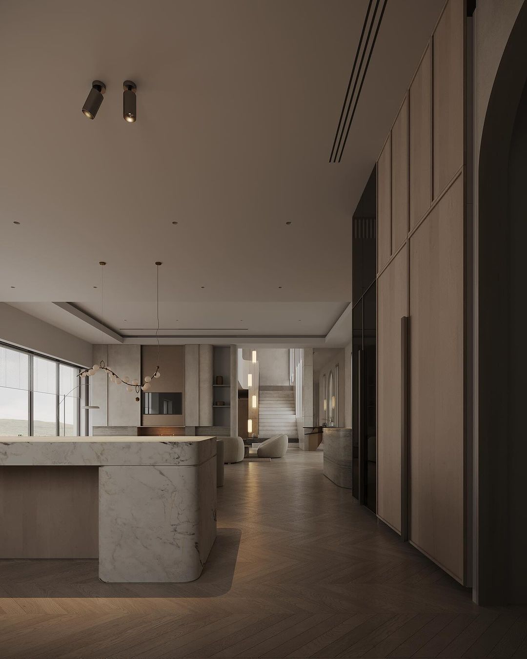 Contemporary open-plan living space with herringbone wood flooring and marble accents