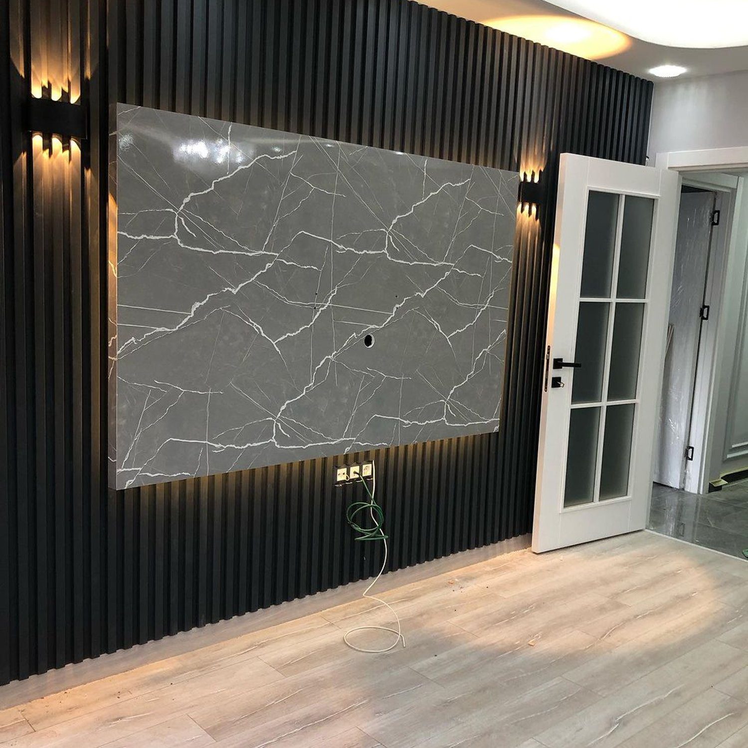 Stylish interior wall with a mounted marble panel