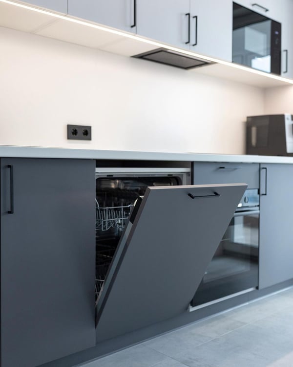 A modern kitchen with an open dishwasher