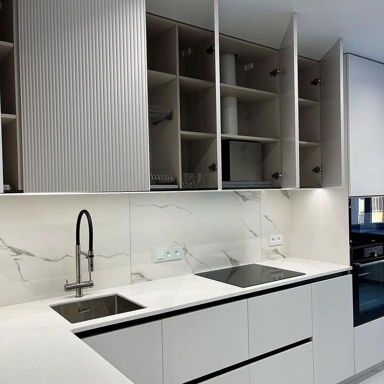 A sleek modern kitchen with marble countertops