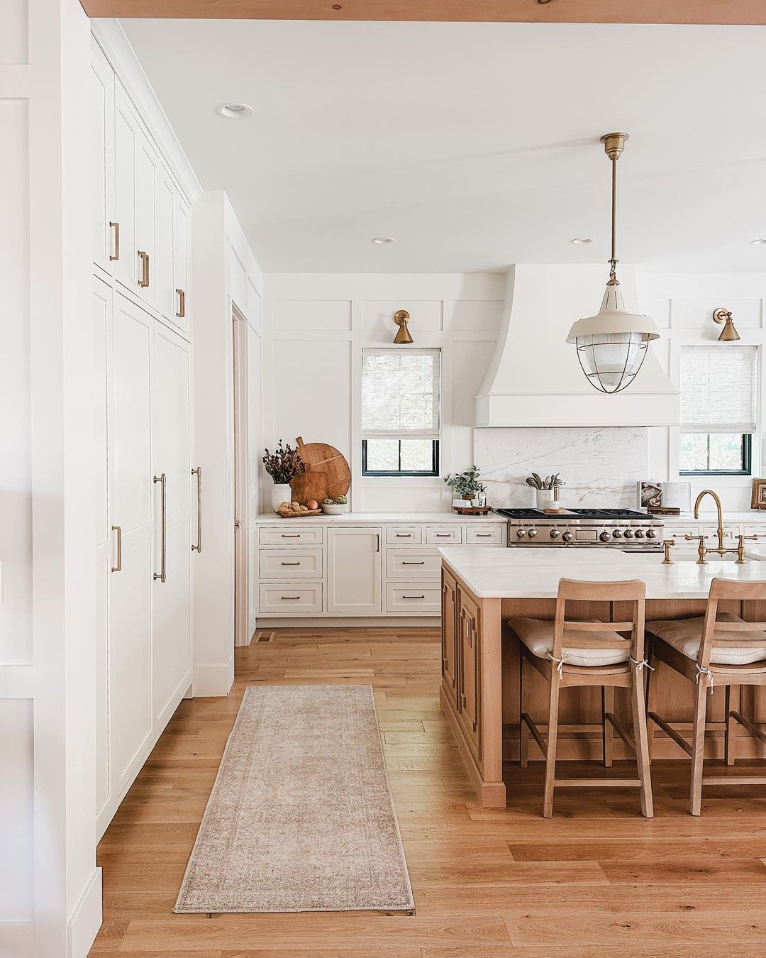 A warm and welcoming kitchen space with wooden floors and marble countertops