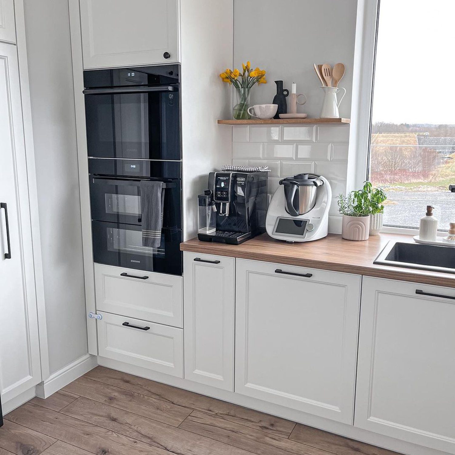 A modern and tidy kitchen featuring high-tech appliances