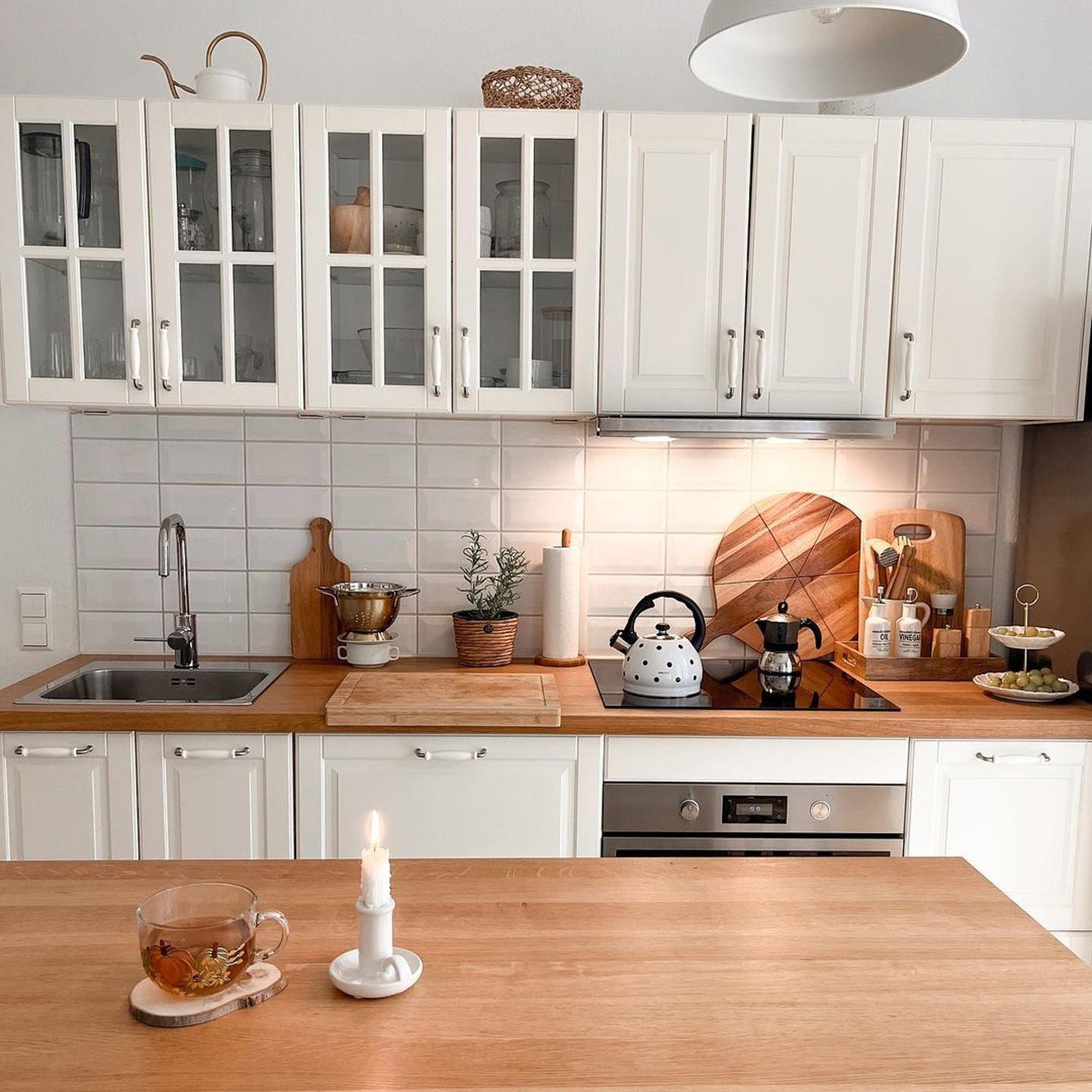 A neatly organized kitchen with white cabinets and modern appliances