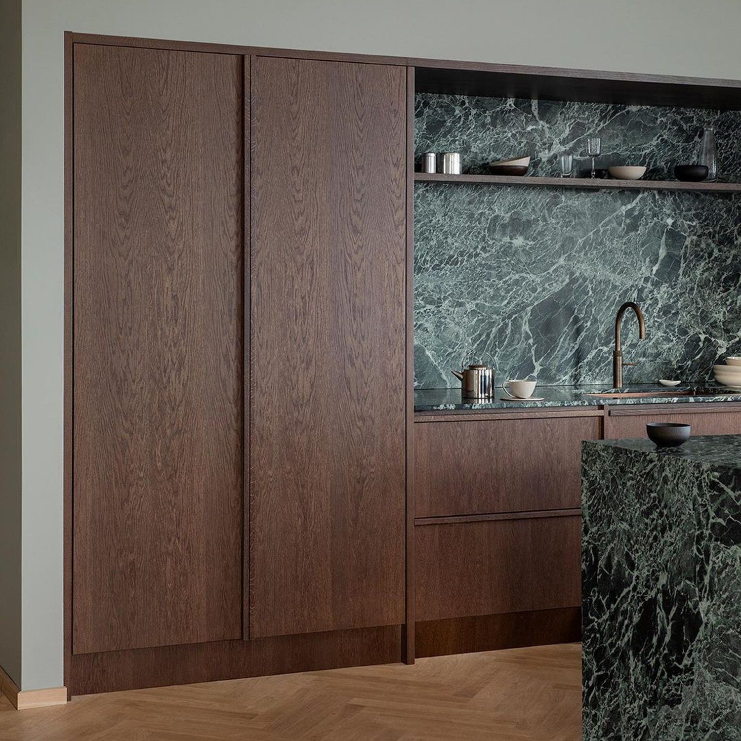 A sleek and modern kitchen with wood and marble finishes