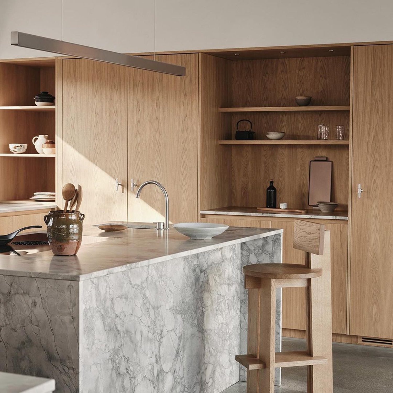 A tastefully designed kitchen with natural wood and marble elements