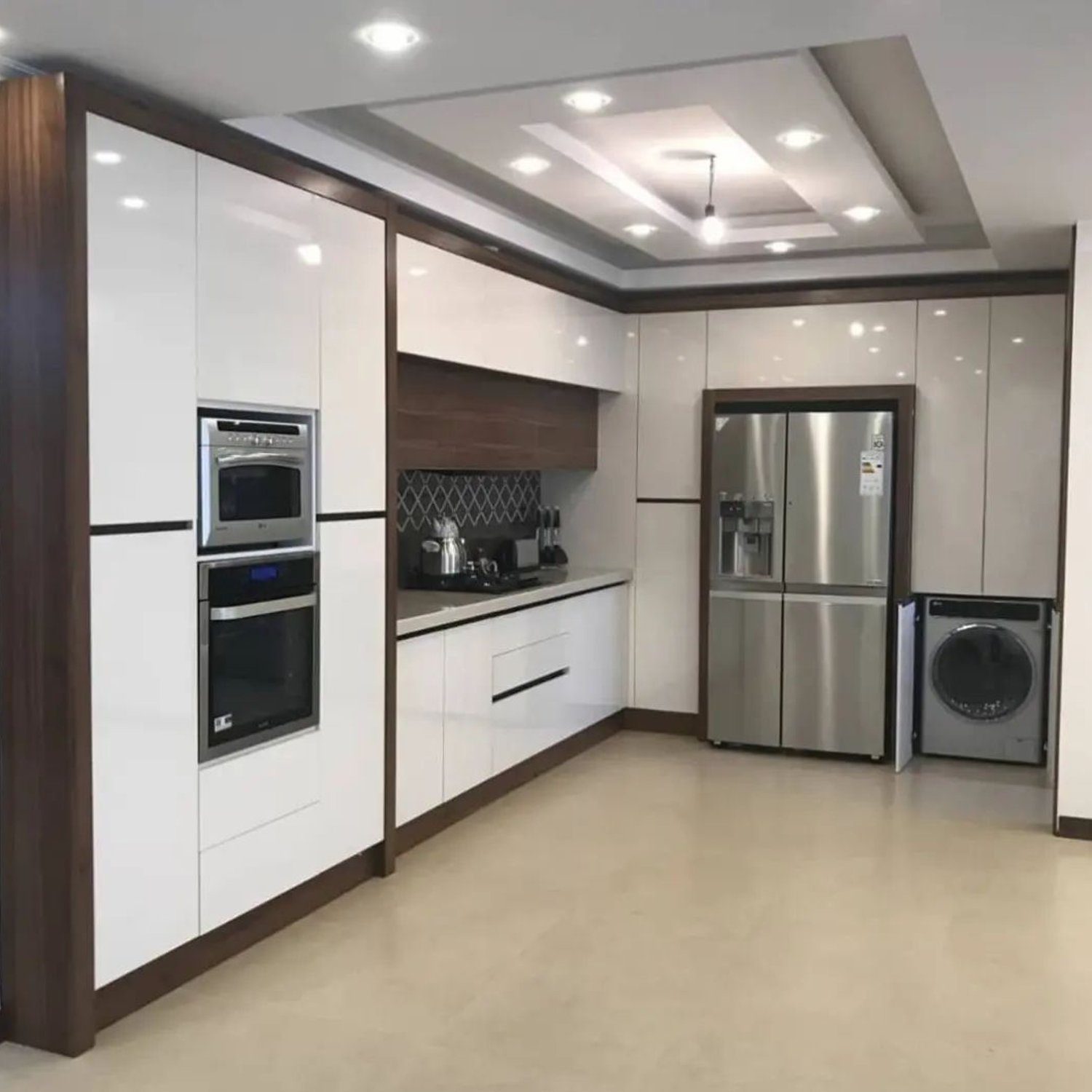 A modern, spacious kitchen with sleek white cabinetry, wooden accents, and stainless steel appliances.