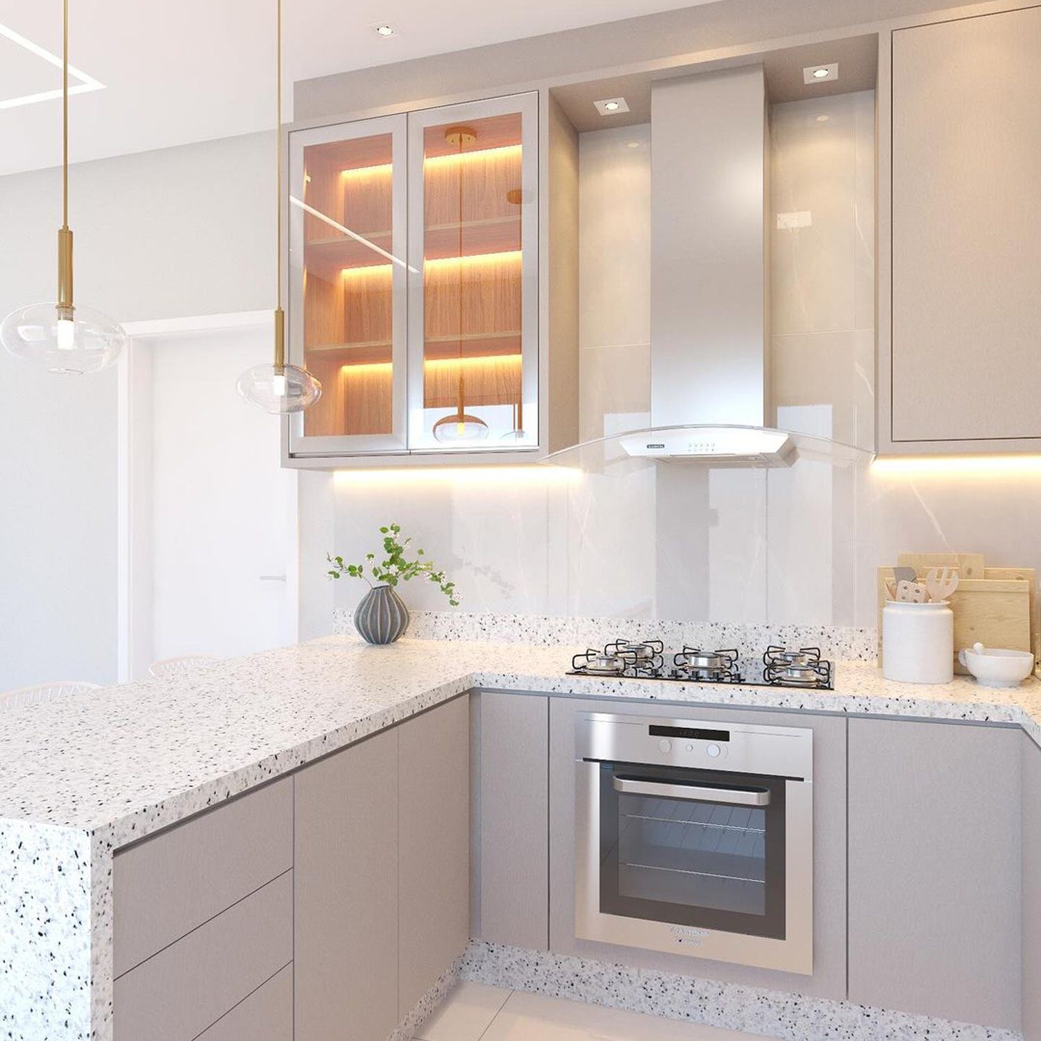 A modern kitchen featuring an L-shaped layout with sleek grey cabinetry, speckled countertops, and integrated lighting