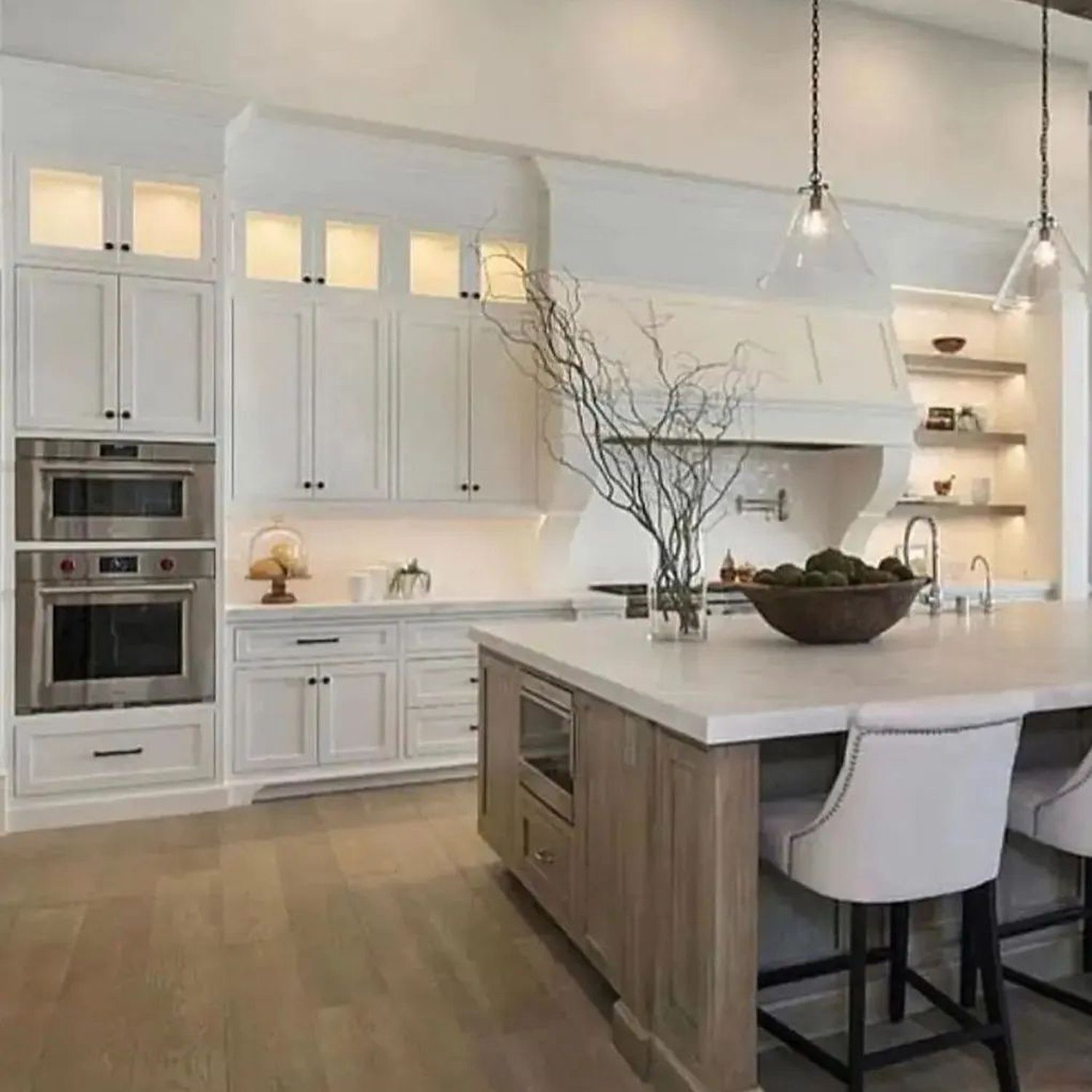 Elegantly designed modern kitchen with white cabinetry and wooden accents