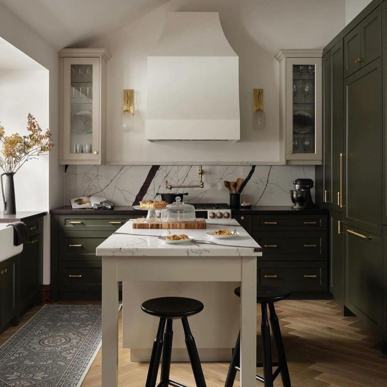 Elegant kitchen space with dark cabinets and marble accents