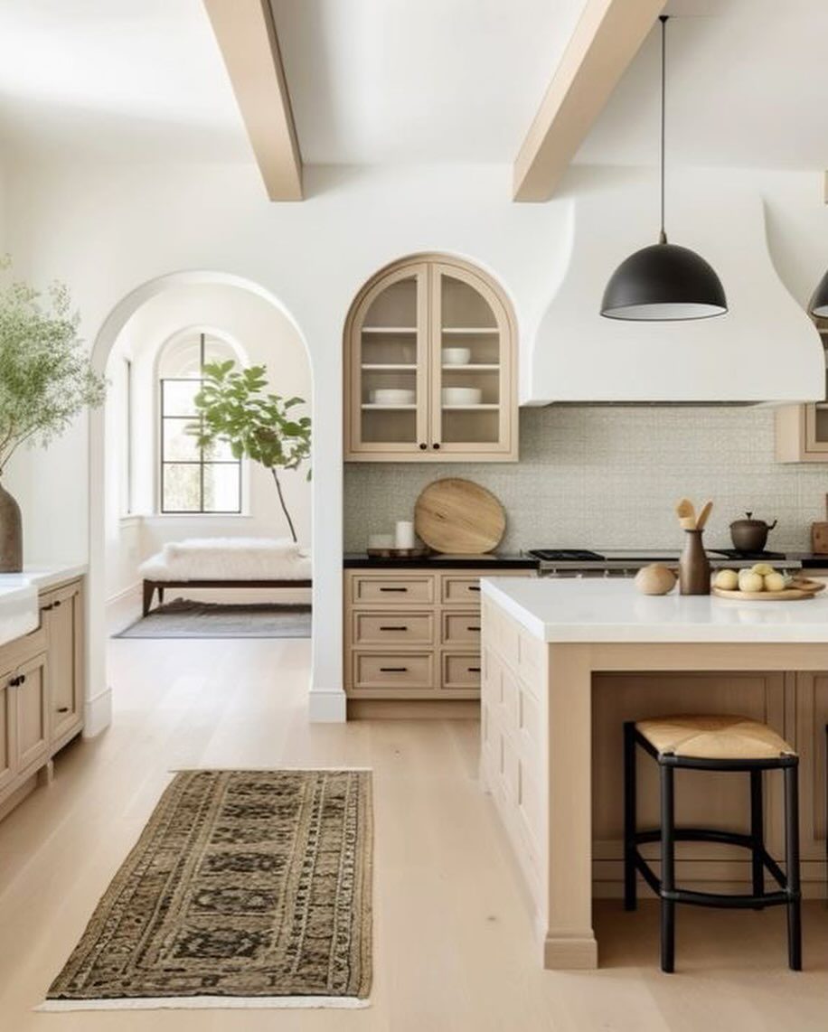 A serene and stylish kitchen space with arched windows and natural wood accents