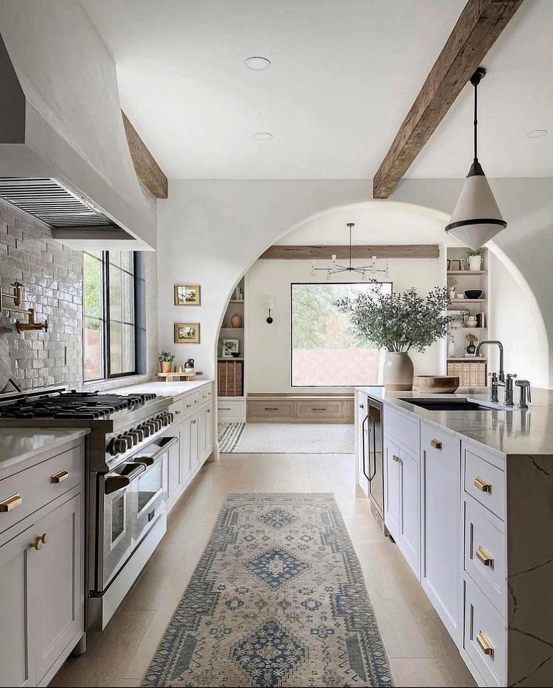 A modern kitchen with exposed wooden beams