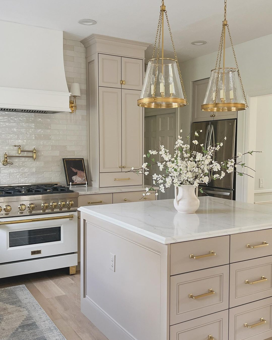 A tastefully designed kitchen featuring brass accent lighting and hardware