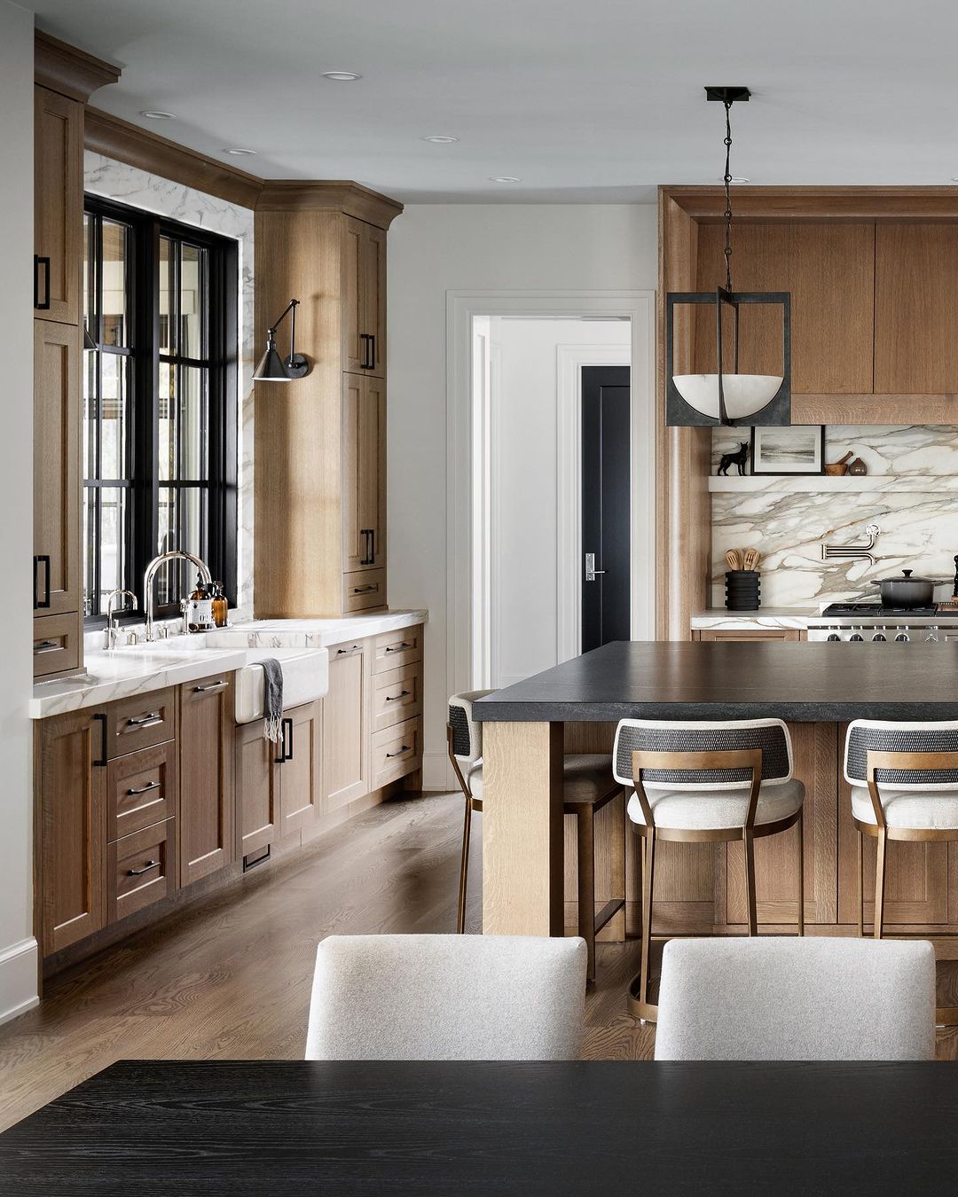 A harmonious blend of natural wooden textures and sleek modern finishes in a kitchen space