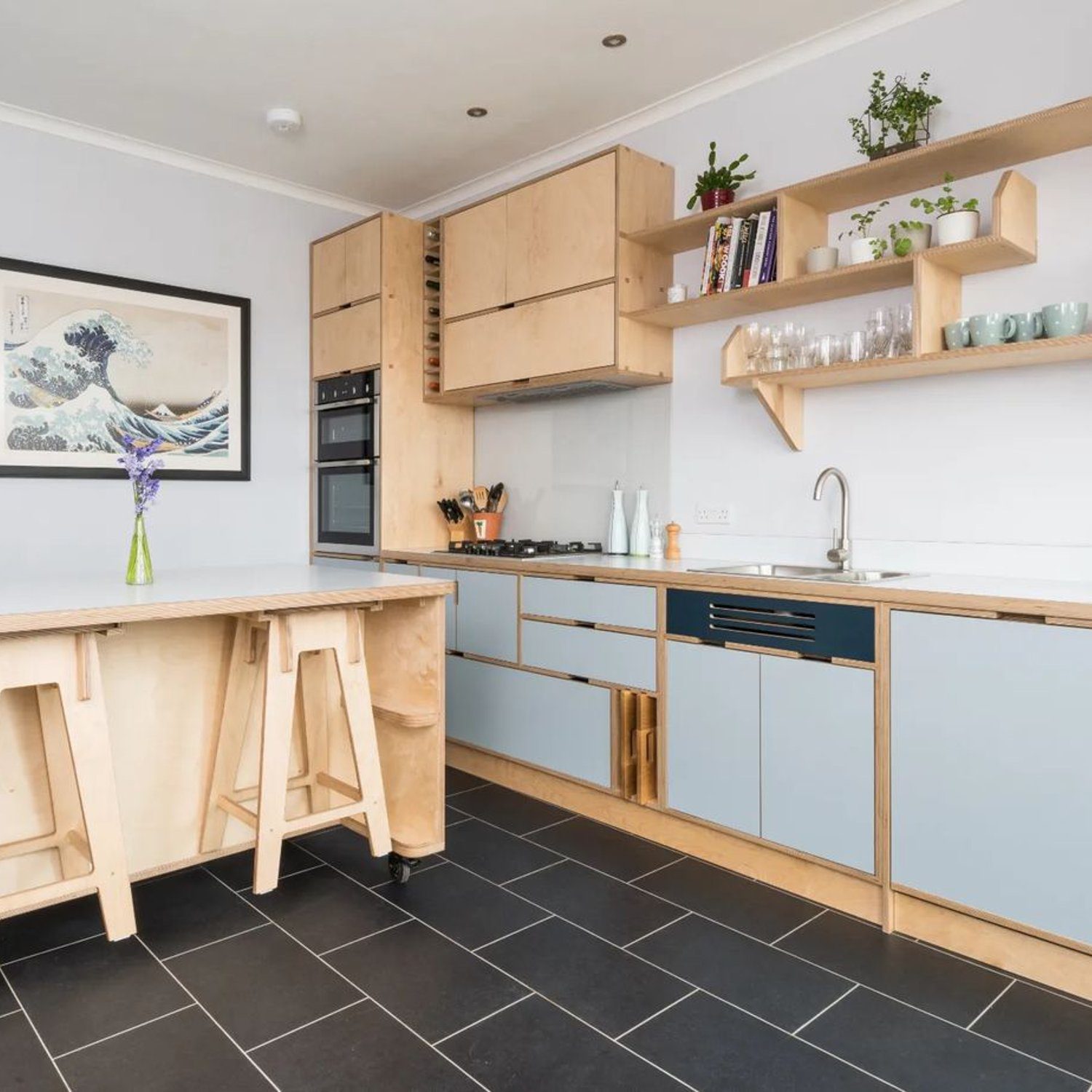 A contemporary kitchen with a harmonious blend of natural wood and calm blue cabinetry