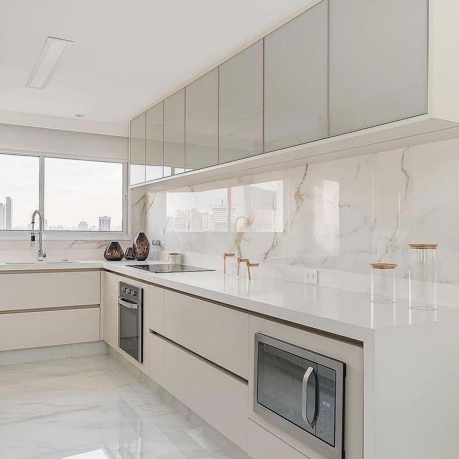 Elegant minimalist kitchen with a marble backsplash and sleek cabinetry