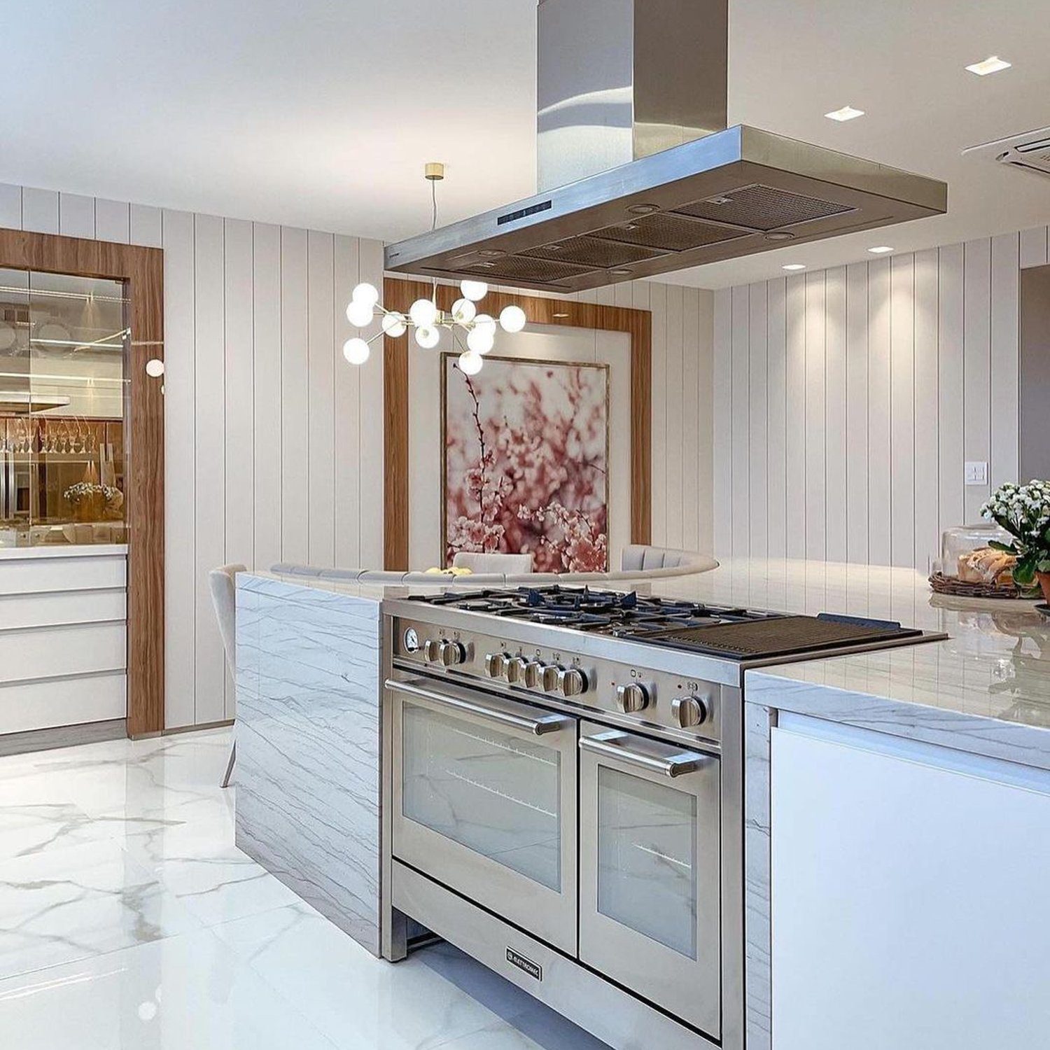 A sleek, modern kitchen design with marble finishes and state-of-the-art appliances.